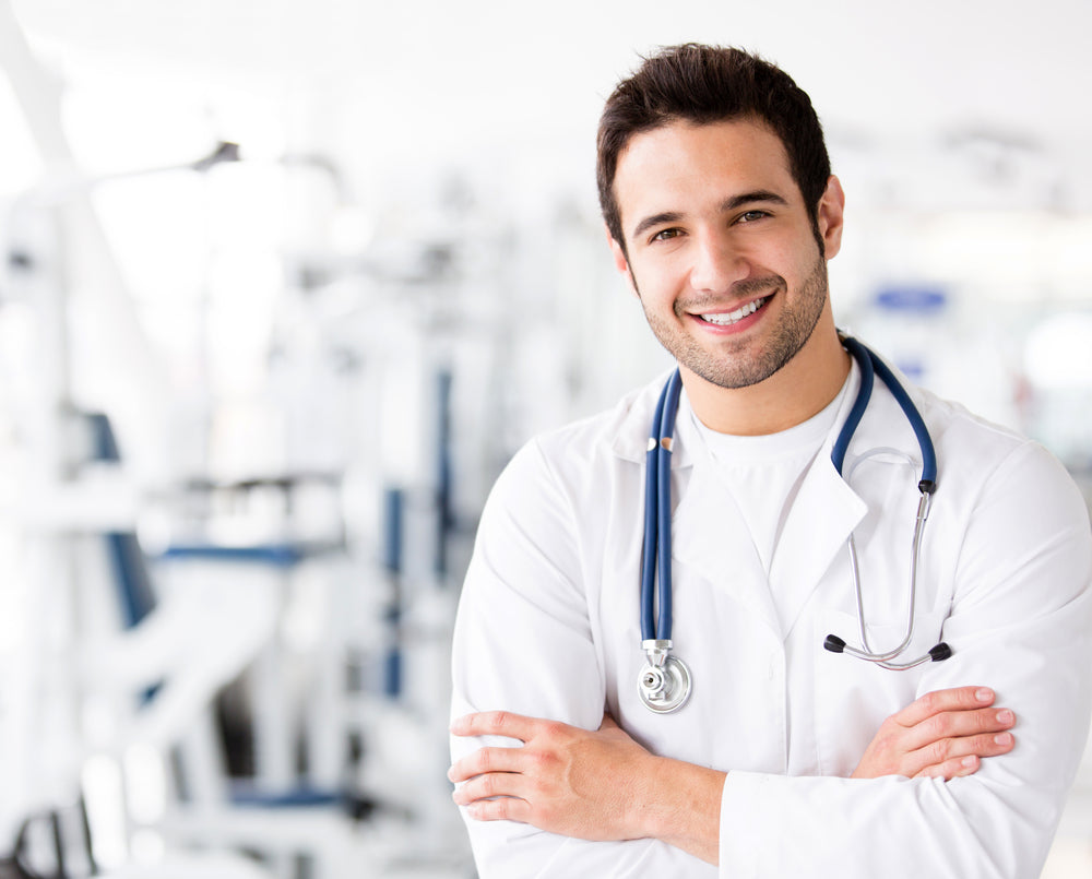 
          
            a medical doctor smiling with medical equipment in the background
          
        