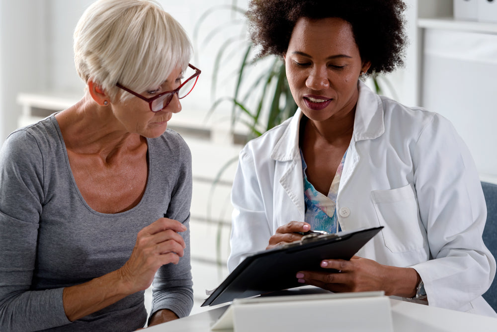 
                postmenopausal woman meeting her her doctor to discuss her options regarding HRT
              