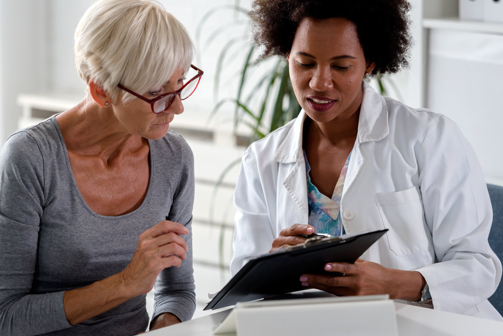 
          
            postmenopausal woman meeting her her doctor to discuss her options regarding HRT
          
        